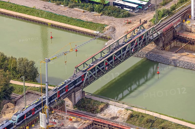 Aerial view, S-Bahn over a railway bridge Wesel-Datteln-Kanal, construction site and demolition of a second railway line with bridge, Friedrichsfeld, Voerde, Ruhr area, North Rhine-Westphalia, Germany, demolition work, construction work, construction area, building site, building plots, construction project, construction site, DE, Europe, aerial view, aerial photography, aerial photography, Lower Rhine, overview, Voerde (Lower Rhine), bird's eye view, birds-eyes view, overview