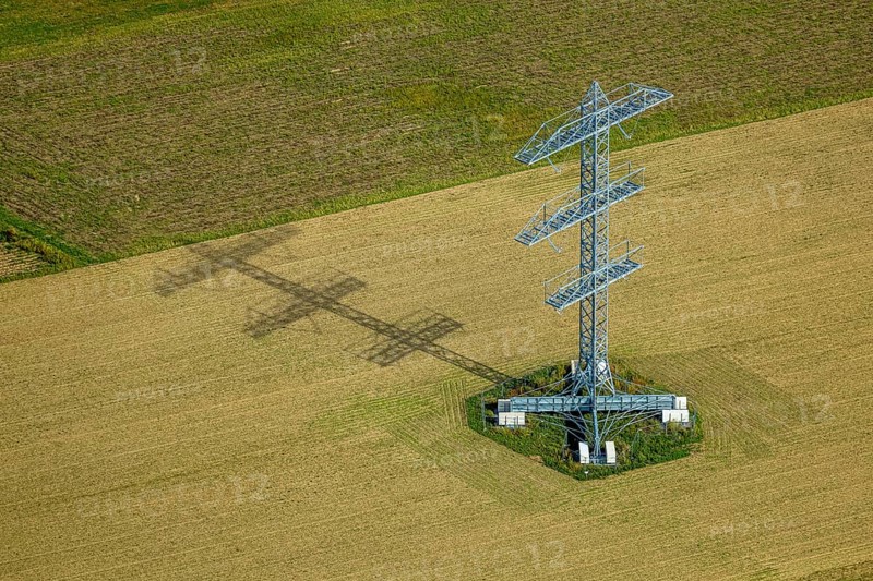 Aerial view, power line project with power pole construction for power line at Hammweg, power pole with shadow on a field, Voerde, Ruhr area, North Rhine-Westphalia, Germany, DE, Europe, aerial view, aerial photography, aerial photography, Lower Rhine, shadow casting, technology and nature, overview, Voerde (Lower Rhine), bird's eye view, birds-eyes view, overview