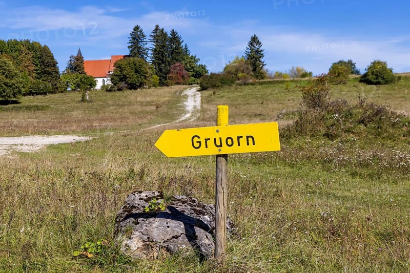 Gruorn is a deserted village near Münsingen in the Swabian Alb. The former village is located in the former military training area and has been part of the newly established Swabian Alb biosphere reserve since 2008. Landscape with signpost and St Stephen's Church. Münsingen, Baden-Württemberg, Germany