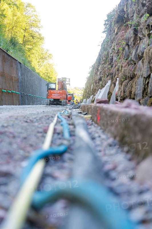 Cable and rock wall on a construction site with construction machinery, Hermann Hessebahn construction site, Calw, Germany