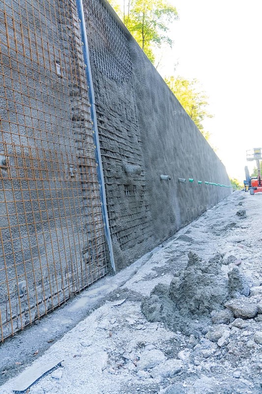 Construction site with a long concrete wall reinforced by wire mesh, Hermann Hessebahn construction site, Calw, Germany