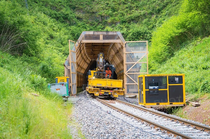 Construction vehicle near a tunnel in a green, natural environment, construction of the Hermann Hesse railway, Calw, Black Forest, Germany