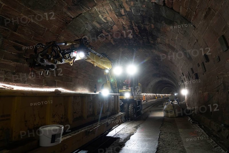 Tunnel lighting with track under construction and heavy machinery, construction of the Hermann Hesse railway, Calw, Black Forest, Germany