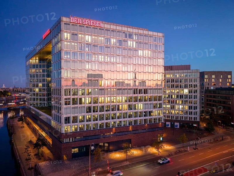 Aerial view of the Spiegel building with glass façade and illuminated offices at blue hour, Hamburg, Germany