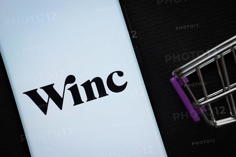 Dhaka, Bangladesh- 03 July 2025: A smartphone displaying the Winc logo next to a miniature shopping cart on a background