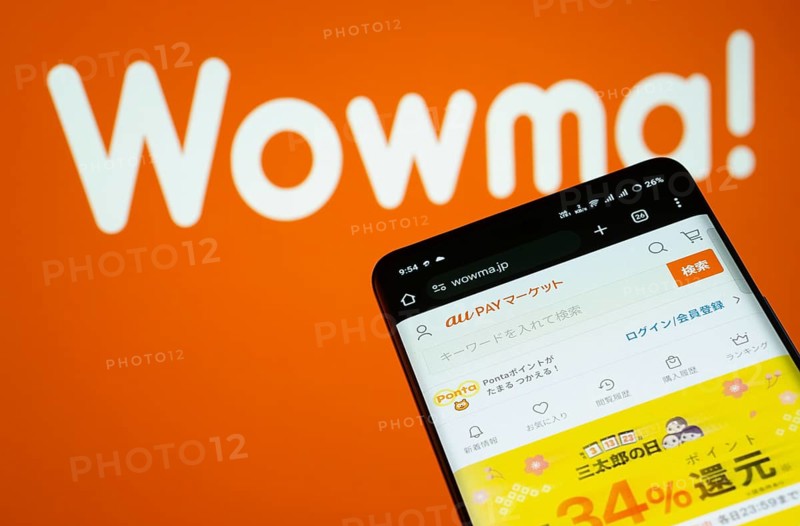 Dhaka, Bangladesh- 03 July 2025: Smartphone displaying wowma web interface against wowma logo background