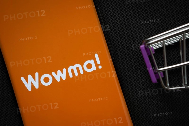 Dhaka, Bangladesh- 03 July 2025: A smartphone displaying the Wowma logo next to a miniature shopping cart on a background