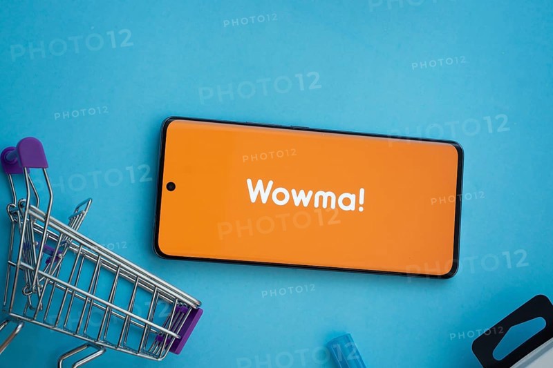 Dhaka, Bangladesh- 03 July 2025: Smartphone displaying wowma logo with shopping cart on a blue background
