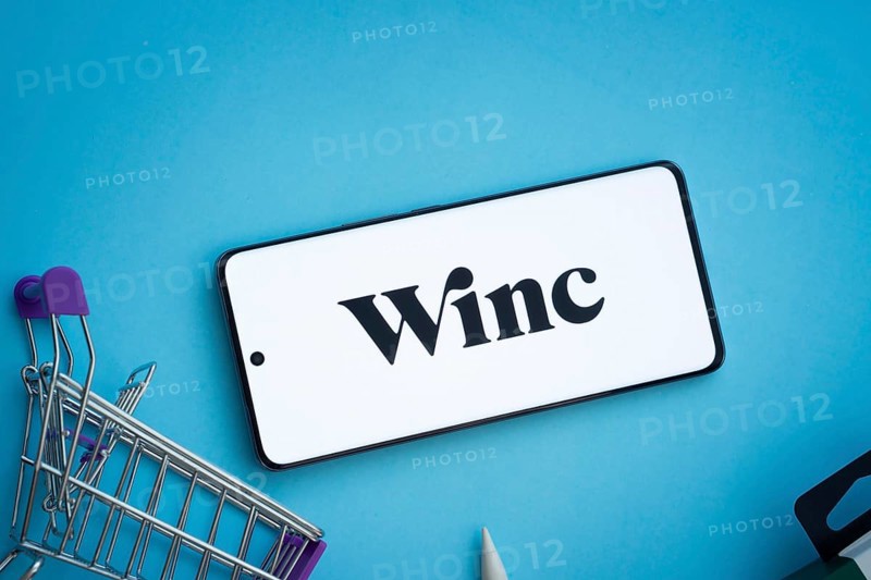 Dhaka, Bangladesh- 03 July 2025: Smartphone displaying Winc logo with shopping cart on a blue background