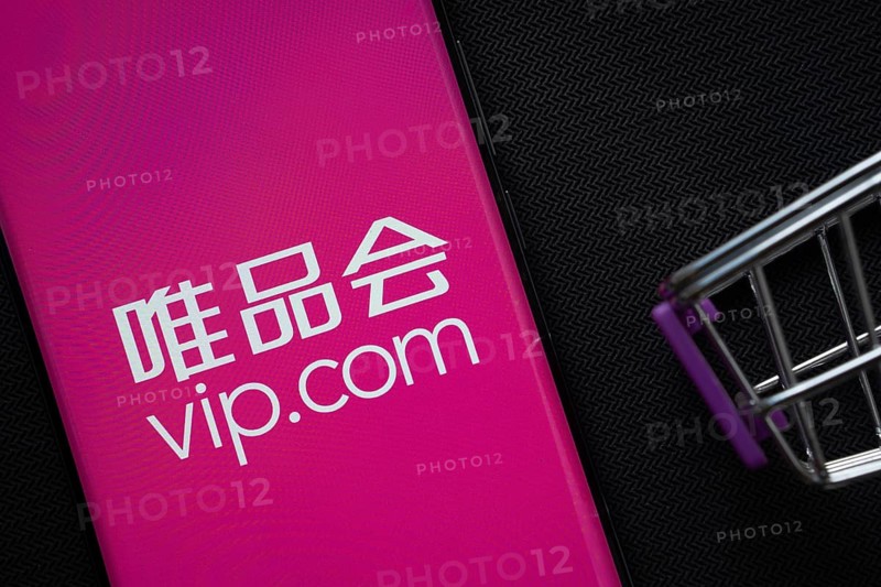 Dhaka, Bangladesh- 03 July 2025: A smartphone displaying the vip.com logo next to a miniature shopping cart on a background