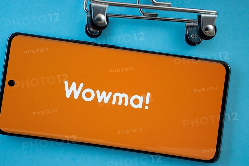 Dhaka, Bangladesh- 03 July 2025: Smartphone screen showing the wowma logo with shopping cart wheels on a blue background