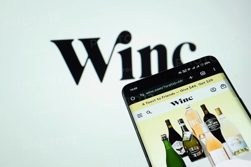 Dhaka, Bangladesh- 03 July 2025: Smartphone displaying Winc web interface against Winc logo background