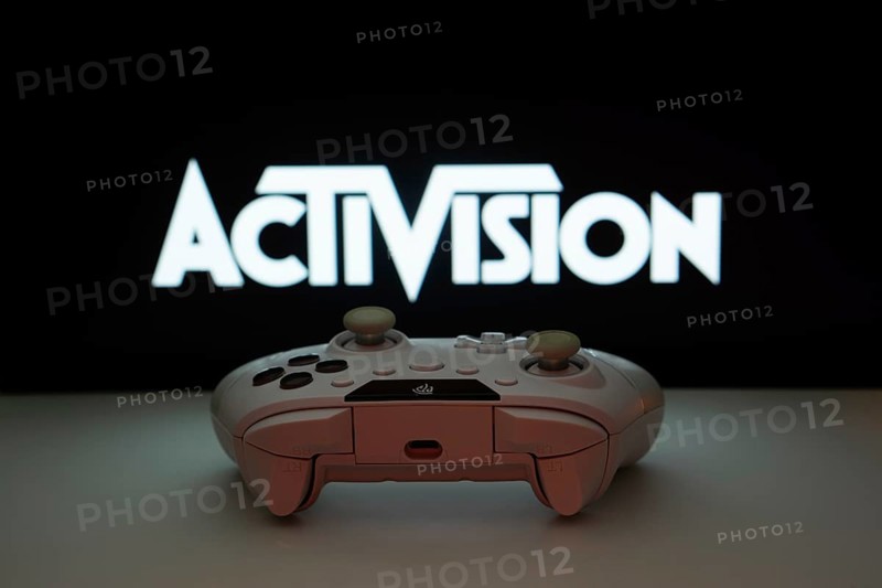 Dhaka, Bangladesh- 23 Sep 2025: A close-up of a white gamepad with the Activision seen on screen in the background