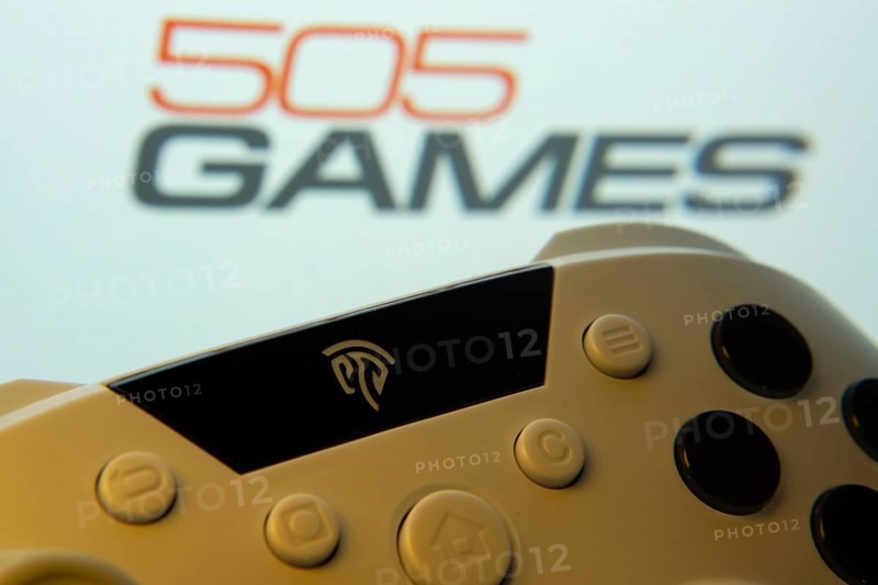 Dhaka, Bangladesh- 23 Sep 2025: A close-up of a gamepad with the 505 Games seen on screen in the background
