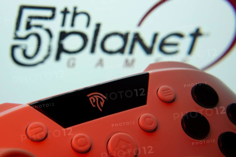 Dhaka, Bangladesh- 23 Sep 2025: A close-up of a gamepad with the 5th planet games seen on screen in the background
