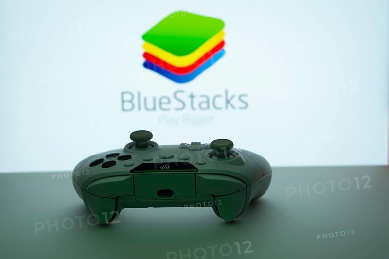 Dhaka, Bangladesh- 23 Sep 2025: Game controller in front of BlueStacks logo on a background