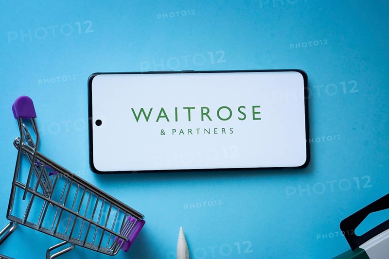 Dhaka, Bangladesh- 03 July 2025: Smartphone displaying Waitrose & Partners logo with shopping cart on a blue background