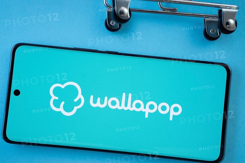 Dhaka, Bangladesh- 03 July 2025: Smartphone screen showing the Wallapop logo with shopping cart wheels on a blue background