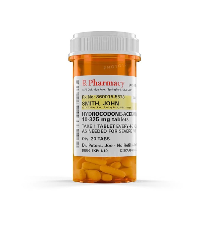 Hydrocodone prescription medicine bottle and pills isolated on a white background. the label is non-proprietary - fictional - made specifically for the stock photo industry