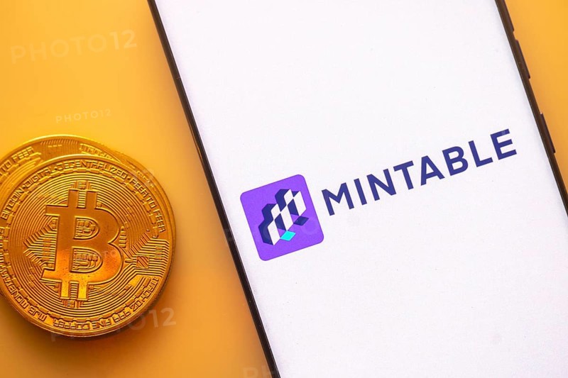 A Bitcoin and Mintable logo on a white screen with a purple square