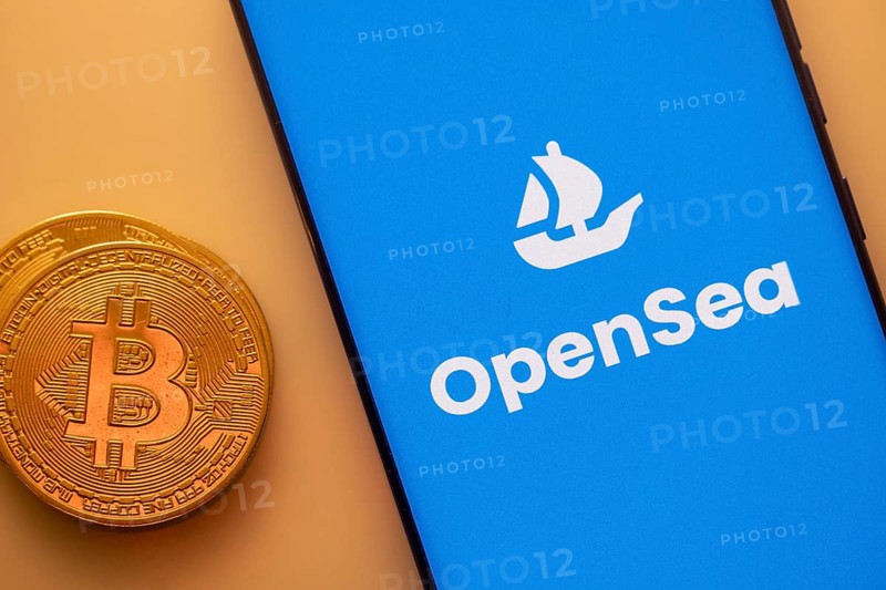 A Bitcoin coin next to an OpenSea logo on a blue background