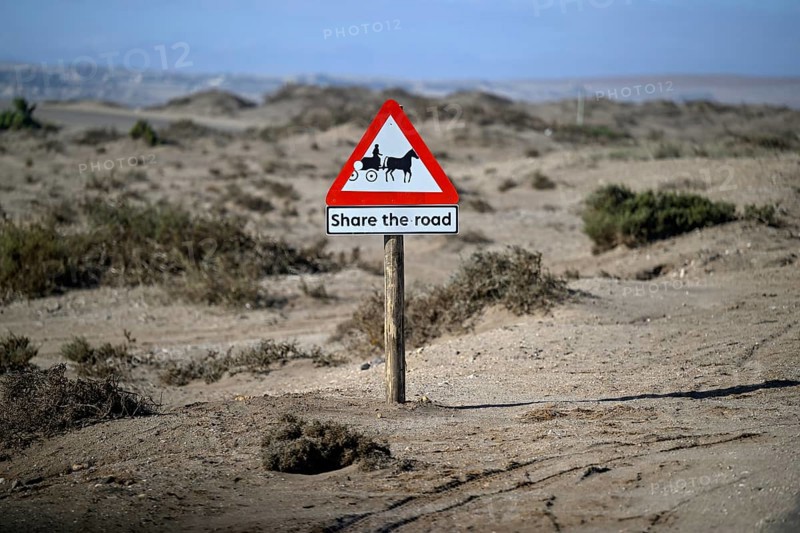 Sign Caution carriages on a road near Oranjemund, diamond restricted area, Karas region, Namibia
