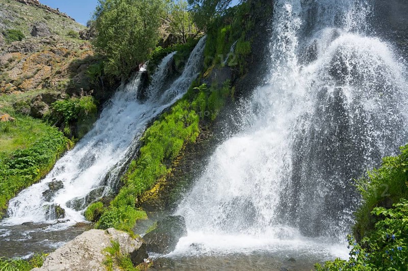 A rushing waterfall flows over moss-covered rocks in a green setting, Shaki Waterfall, Shaki, Syunik Province, Armenia