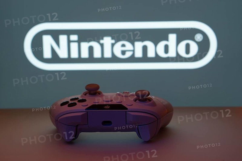 Dhaka, Bangladesh- 15 July 2025: A close-up of a gamepad with the nintendo seen on screen in the background