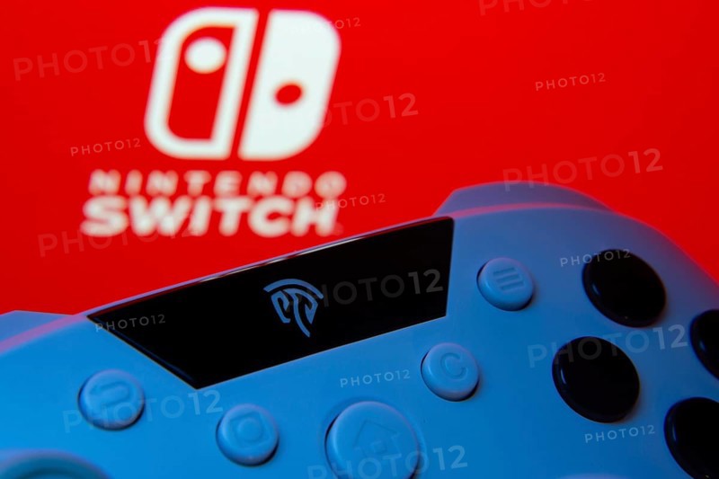 Dhaka, Bangladesh- 15 July 2025: A close-up of a gamepad with thenintendo switch seen on screen in the background