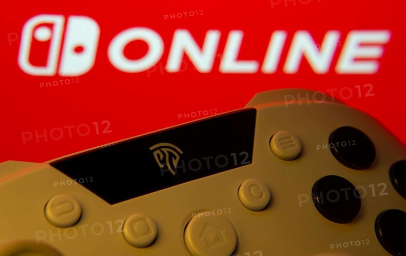 Dhaka, Bangladesh- 15 July 2025: Game controller in front of nintendo online logo on a background
