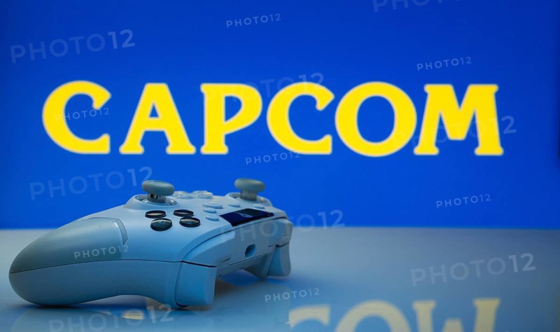 Dhaka, Bangladesh- 19 Sep 2025: A close-up of a white gamepad with the Capcom seen on screen in the background