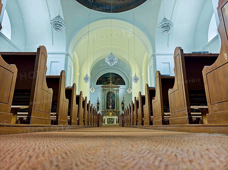 Church interior with view of the altar, wooden benches and quiet atmosphere, Kammersdorf Hollabrunn Weinviertel Lower Austria Austria