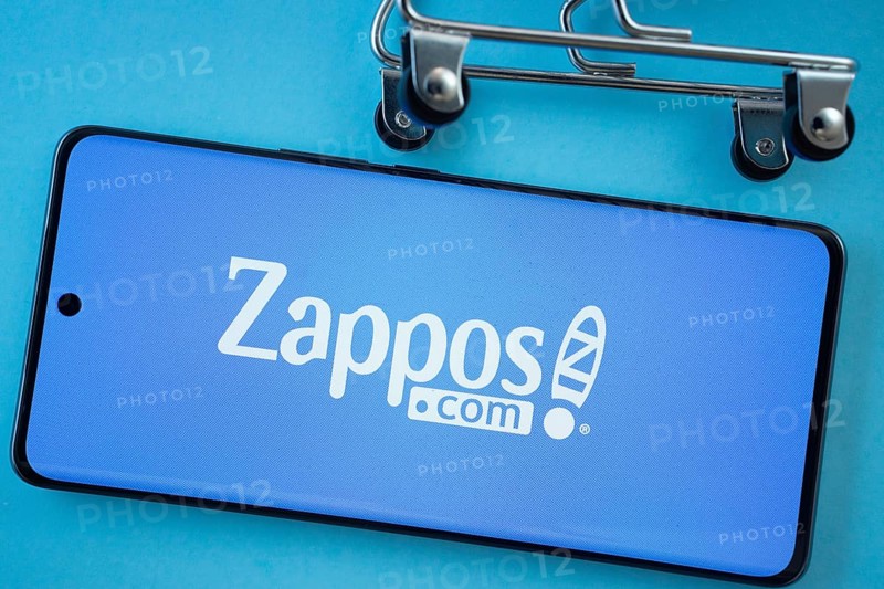 Dhaka, Bangladesh- 03 July 2025: Smartphone screen showing the Zappos logo with shopping cart wheels on a blue background