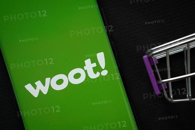 Dhaka, Bangladesh- 03 July 2025: A smartphone displaying the Woot logo next to a miniature shopping cart on a background