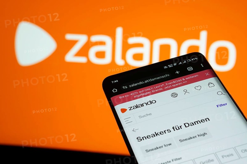 Dhaka, Bangladesh- 03 July 2025: Smartphone displaying Zalando web interface against Zalando logo background