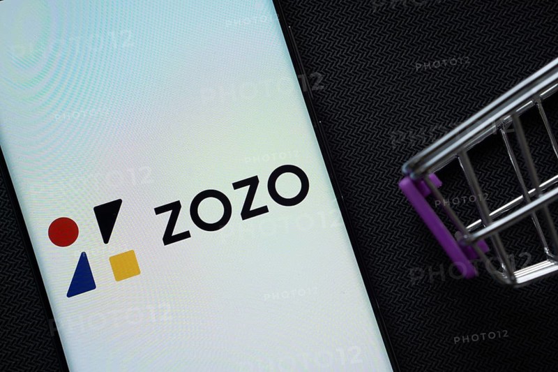 Dhaka, Bangladesh- 03 July 2025: A smartphone displaying the ZOZO logo next to a miniature shopping cart on a background