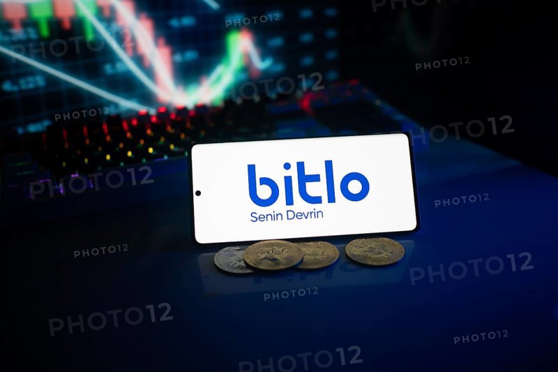 Bitlo logo displayed in front of colorful trading charts and coins with a neon ambiance