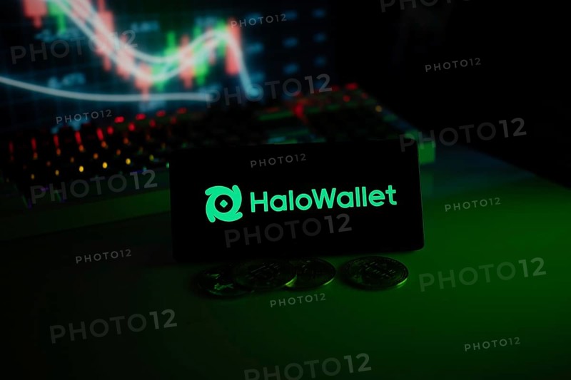 HaloWallet logo highlighted with coins and colorful trading charts in a modern trading ambiance