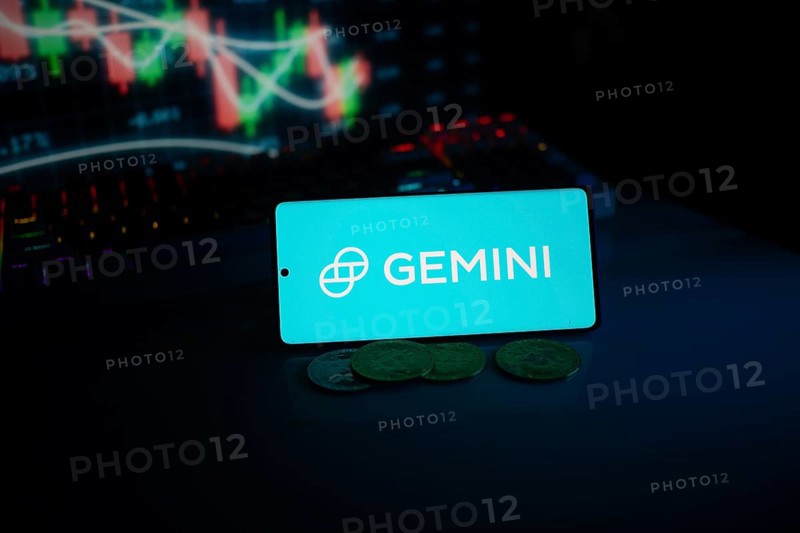 Gemini logo displayed amid coins and glowing trading charts, suggesting modern finance themes