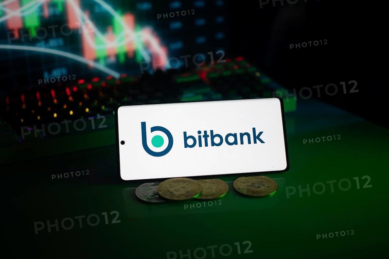 Bitbank logo displayed with coins and market charts, surrounded by neon lighting