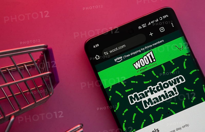 Dhaka, Bangladesh- 23 June 2025: A smartphone displaying the Woot website with a shopping cart is shown on a vibrant background