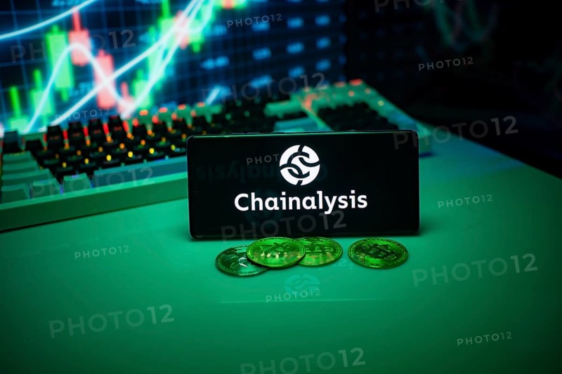 Chainalysis shown on a smartphone with currency and financial data displayed