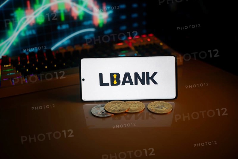 Phone displays LBank logo with crypto coins and trading screen in background