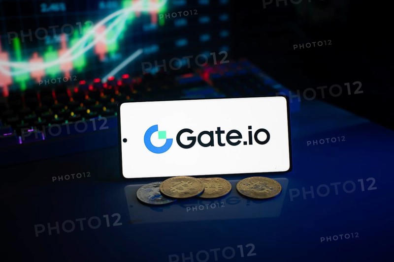 Gate.io logo on smartphone with coins, neon lights, and trading charts in background