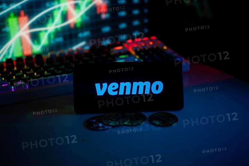Venmo logo with coins and market activity graph in vibrant neon atmosphere