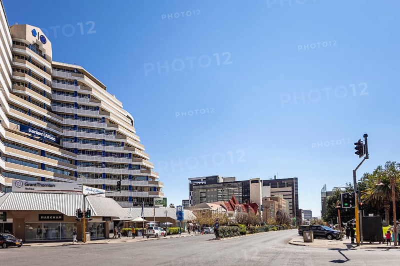 Modern downtown Windhoek, Namibia - 11 August, 2025: with tall contemporary buildings, wide streets, moving cars, and a clear blue sky