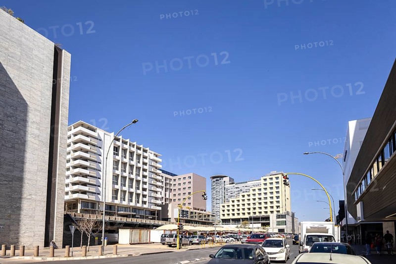 Modern downtown Windhoek, Namibia - 11 August, 2025: with tall contemporary buildings, wide streets, moving cars, and a clear blue sky