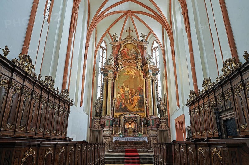 Magnificently designed church altar with rich wood carving and large painting in the background, St.Stephan's parish church in Tulln Lower Austria Austria