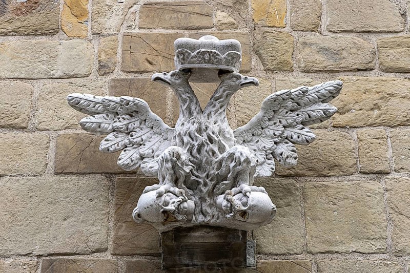 Stone relief of a crowned eagle, symmetrically and artistically embedded in a wall, St.Stephan's parish church in Tulln Lower Austria Austria