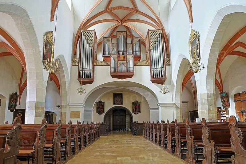 View into the interior of a church with high vaulted ceilings and an impressive organ on the wall, parish church St.Stephan Tulln Lower Austria Austria